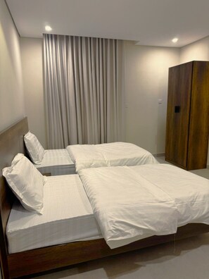 Minibar, tabla de planchar con plancha y ropa de cama 