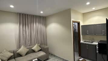 Superior Apartment, 1 King Bed | Living room | 100-inch Smart TV with satellite channels