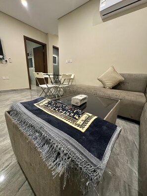 Relax in this stylish living room with a sofa, coffee table, and comfortable seating for two.