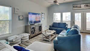 A living room with a sofa set, a television, and a coffee table.