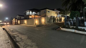 A two-story house with a balcony and a gated entrance. - Chester Hill Residence  (Kwabenya)