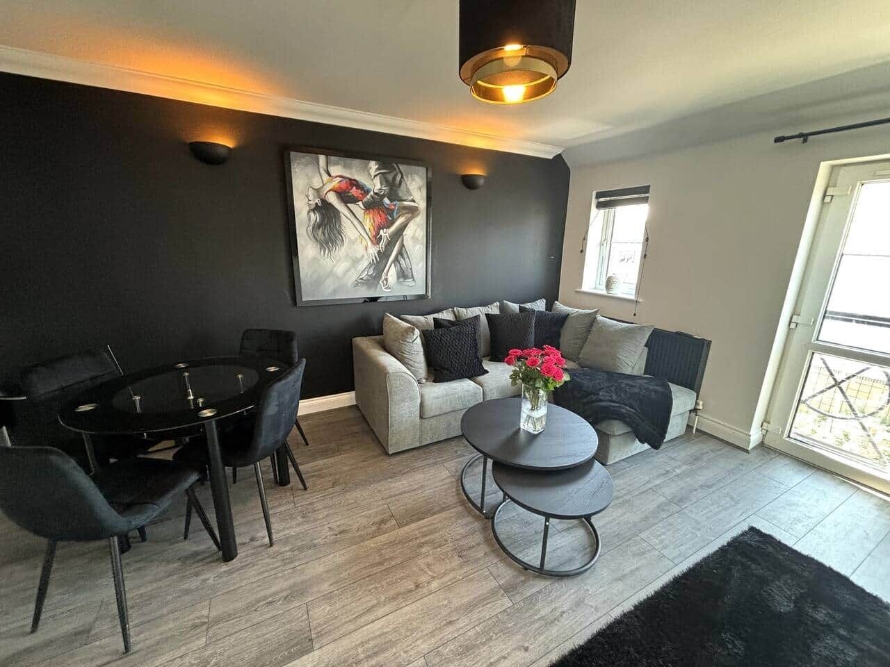 A modern living room with a dining table, sofa, and coffee table.