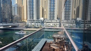 A high-rise building with a glass-bottomed pool and a chair. - Lux Marina-View 2 Bedroom Unit, Walking Distance to JBR Beach, Metro & Tram. (Dubai)