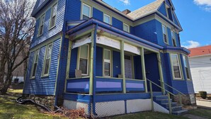 A two-story building with a blue exterior and a porch. - Charming 4-bedroom family friendly house in Monongahela. Make yourself at home! (Monongahela)