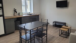A modern kitchen with a dining area, a built-in oven, a sink, and a window. - Charming triplex near Disney  (Quincy-Voisins)
