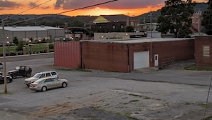 A parking lot with a building in the background, a sign for "Rotary Main Stage," and a tree on the right.