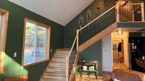 A multi-level wooden staircase with a view of a patio outside.