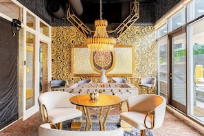 Relax in style with a round table and comfortable chairs, surrounded by a stunning chandelier and city views from the balcony.