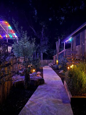 A wooden pathway leading to a cabin with a sign reading "L'arboisier". - Wooden cabins surrounded by nature in the south of France. (Clermont-l'Hérault)