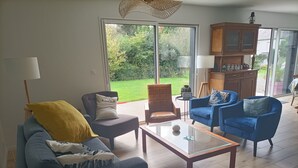 A living room with a sofa, armchairs, a coffee table, and a cabinet. - Village house 5 mn walk from shops and 10 mn from beaches.  (Saint-Briac-sur-Mer)