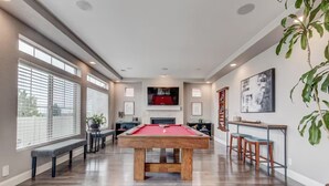 A spacious room with a pool table, a fireplace, and a bar area. - 5400sqft 6BR 5.5BA Theater, Office, Game Room // 10min to DIA & Downtown (Denver)