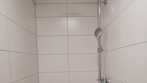 A shower with a handheld showerhead and a wall-mounted control. - Vacation apartments Meyer, between Nuremberg and Ansbach A6/B14, near Playmobil Fun Park (Heilsbronn)