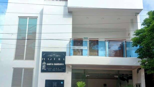 A hotel with a sign reading "HOTEL SANTA BARBARA" and a contact number. - Hotel Santa Bárbara Mompox  (Mompos)