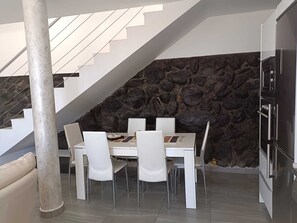 Enjoy meals in the dining area with a white table and chairs.