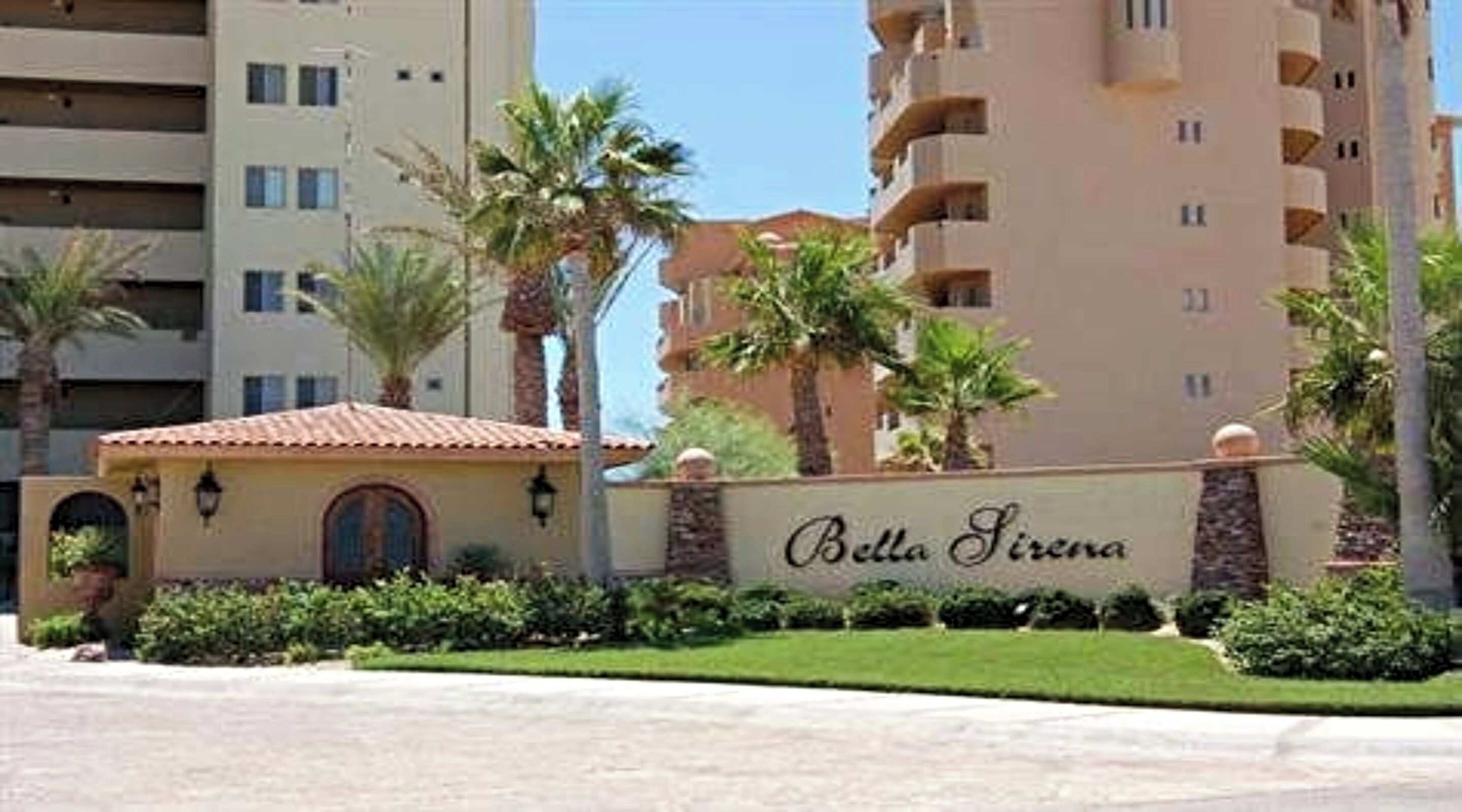 A sign for 'Bella Sirena' with a building in the background.