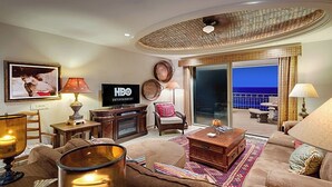 A living room with a flat-screen TV, a fireplace, a comfortable sofa, and a view of the ocean through large sliding doors. - Condo Bella Sirena 805 C by Kivoya (Puerto Peñasco)