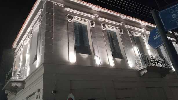 A building with classical architecture, featuring columns and a balcony with ornate railings. - 1920  classic (Kalamata)