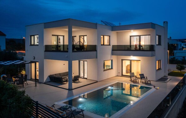 A modern two-story house with a swimming pool, outdoor seating, and a covered patio. - Awesome home in Primosten (Primosten)
