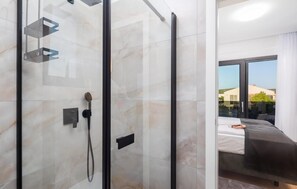 A modern bathroom with a glass shower enclosure, a visible showerhead, and a control panel. - Awesome home in Primosten (Primosten)