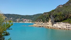 A coastal landscape with clear turquoise waters, rocky shorelines, and a backdrop of hills. - Charming 2-bedroom house with AC, WiFi in amazing Corfu






 (Corfu)