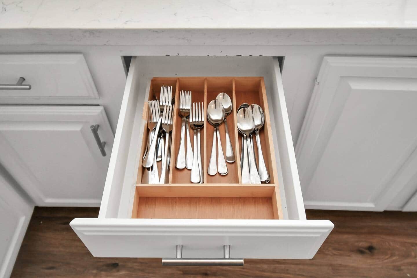 A drawer with utensils neatly organized.