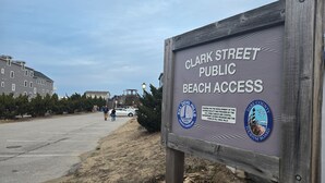 A sign for Clark Street Public Beach Access with logos of Kill Devil Hills and Dare County Tourism Board. - OCEANVIEW CONDO:
Outer Banks Oceanside cozy 2-bedroom condo in Kill Devil Hills. (Kill Devil Hills)