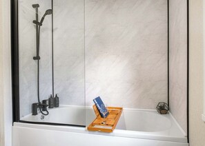 A bathroom with a shower, a bathtub, and a glass-enclosed shower area. - Premium modern and contemporary luxury lodge perfect for a relaxing escape. (Workington)