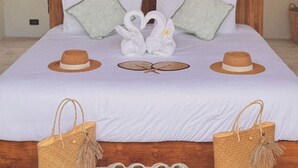 A bed with a wooden headboard, white bedding, and decorative pillows. There are two woven bags and a pair of slippers on the floor. - Villa With Private Pool Near Fisherman`s (Bo Phut)