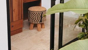 A wooden cabinet with drawers, a small stool with a woven pattern, and a glass door reflecting a plant. - Villa With Private Pool Near Fisherman`s (Bo Phut)