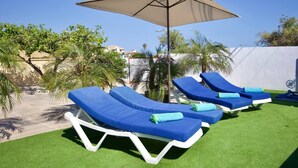 A poolside area with lounge chairs and a canopy. - R009. CASA LIDIA - House with swimming pool (Nerja)