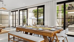 A modern dining area with a large wooden table set for six, white chairs, and a bench. - Kros Villa by Kozystay - Legian (Kuta)