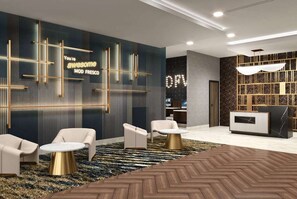 A modern lobby with a reception desk, seating area, and decorative wall panels. - La Quinta Inn & Suites by Wyndham Shonto (SHONTO)