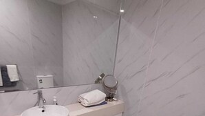 A modern bathroom with a white sink, mirror, and toilet. - Nice Two Bedroom Apartment with courtyard/balcony in secure complex (Kelmscott)