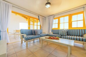 Apartment, 2 Bedrooms, Balcony, Sea View | Living area | 32-inch TV with satellite channels