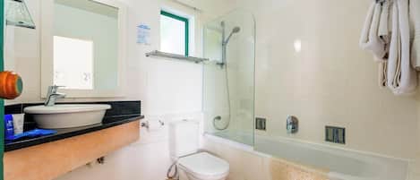 A bathroom with a sink, toilet, shower, and bathtub.