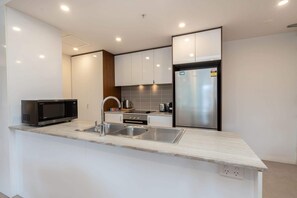 Fridge, microwave, oven, stovetop - Bright 2-Bed Flat Near City Amenities (Lyneham)