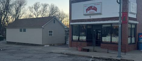 A two-story building with a storefront labeled "Jay's Poplar Pizza."