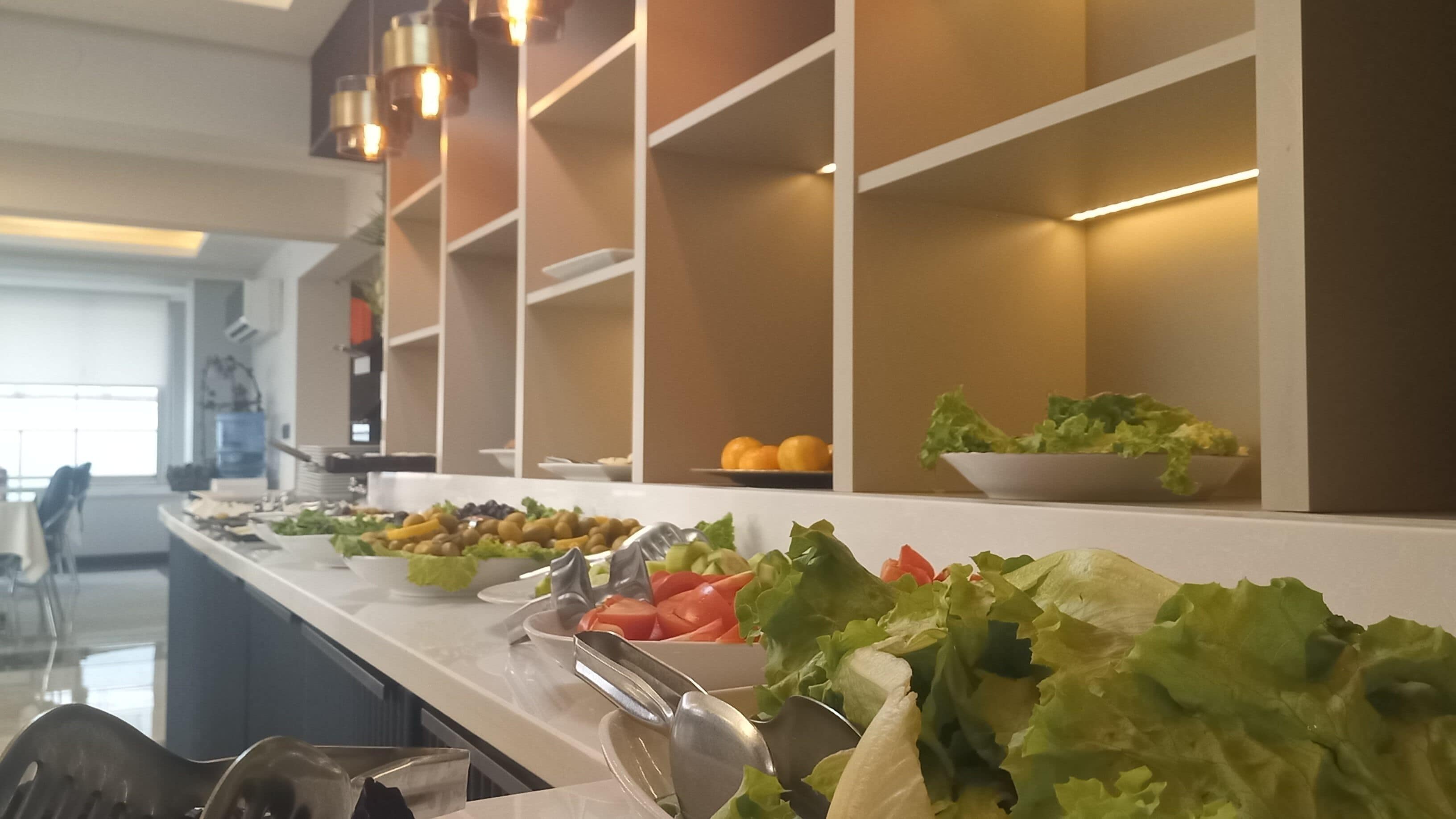 A buffet with various fruits and vegetables.