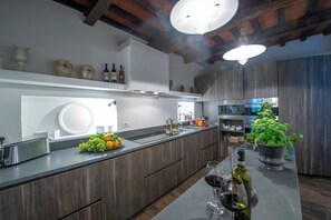 Villa | Private kitchen | Full-size fridge, oven, stovetop, dishwasher