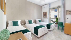 A hotel room with two beds, a desk, a chair, and a balcony with a view. - New Family 3 Bedrooms House In Sorrento (Sorrento)
