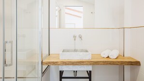A modern bathroom with a glass shower enclosure, a wooden vanity with a marble sink, and two towels on the counter. - Exclusive Suite With Terrace By Sorrento Main Square (Sorrento)