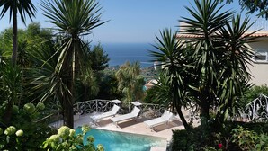 A pool area with lounge chairs and a view of the sea. - Villa With Panoramic Vesuvius And Sorrento Views With Private Pool (Sorrento)