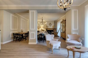 A spacious living room with a dining area, a chandelier, and a fireplace. - Entire Hilltop Villa With Private Pool In Palazzuolo Sul Senio (Palazzuolo sul Senio)