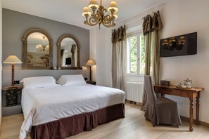 A bedroom with a large bed, two bedside lamps, a wooden desk with a chair, a television, and a window with curtains. - Entire Hilltop Villa With Private Pool In Palazzuolo Sul Senio (Palazzuolo sul Senio)