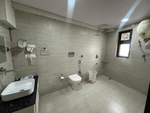 A modern bathroom with a sink, toilet, and bidet. - Hotel Anant Restaurant And Bar (Balh)