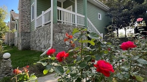 A two-story house with a stone facade and a green exterior. - Rahat  (Khachmaz)