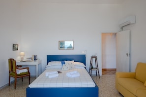 A hotel room with a bed, a desk, a chair, a small table, and a sofa. - Casa Nostra - It Speaks of Love Family and the sea (Praiano)