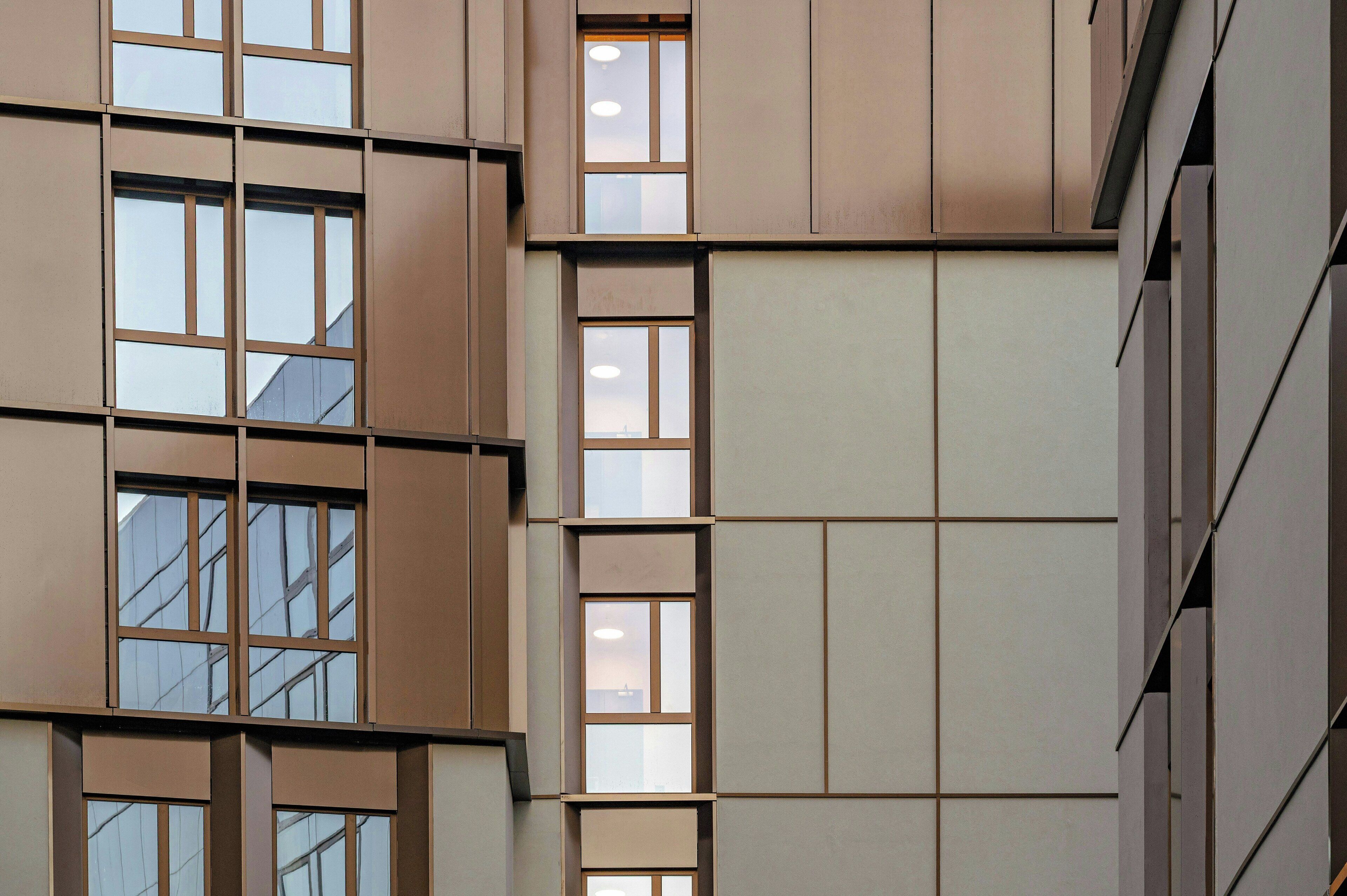 A multi-story building with a grid of windows and a flat facade.