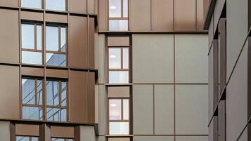 A multi-story building with a grid of windows and a flat facade.