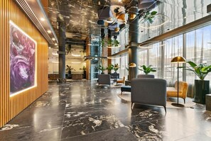 Experience the luxurious lobby, featuring a spacious area with polished floors, comfortable seating, and stunning views of the outdoors.